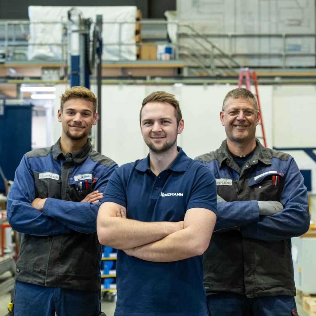 Drei Mitarbeiter in einer Industriehalle bei Renzmann